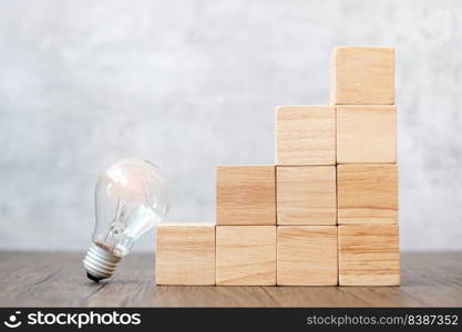 Lightbulb and wood block stack of building with business idea, creative, thinking goal, strategy and innovation concept