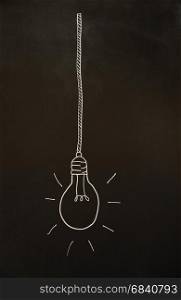 lightbulb on vintage blackboard