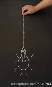 lightbulb on vintage blackboard