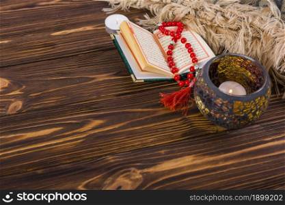 Lighted candle holder; kuran and red prayer beads on wooden desk Picture on pik. Resolution and high quality beautiful photo. Lighted candle holder; kuran and red prayer beads on wooden desk Picture on pik. High quality beautiful photo concept