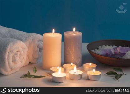 lighted candles rolled up towel bath spa salt table. High resolution photo. lighted candles rolled up towel bath spa salt table. High quality photo