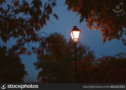 Lighted lantern on a dark blue sky at the beginning of twilight