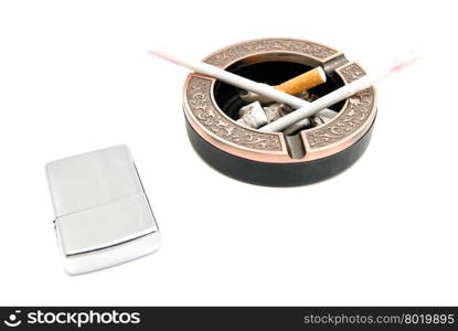 lighter and ashtray with two cigarettes on white