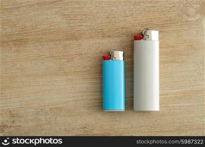 Lighters isolated on a wooden background