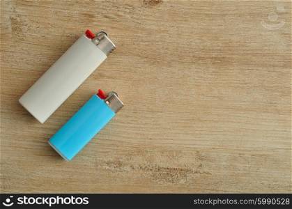 Lighters isolated on a wooden background