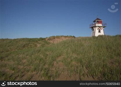 Lighthouse at coast, North Shore, Prince Edward Island National Park, Prince Edward Island, Canada