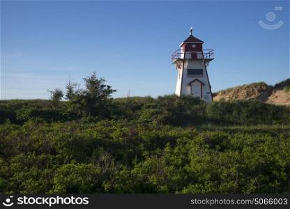 Lighthouse at coast, North Shore, Prince Edward Island National Park, Prince Edward Island, Canada