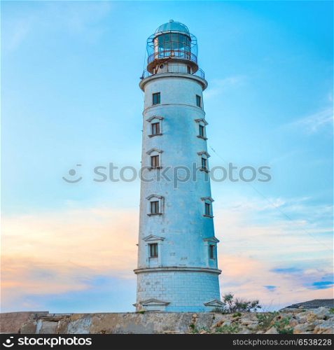 Lighthouse at sea coast. Lighthouse at sea coast with sunset sky