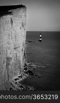 Lighthouse by cliff and sea