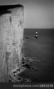Lighthouse by cliff and sea