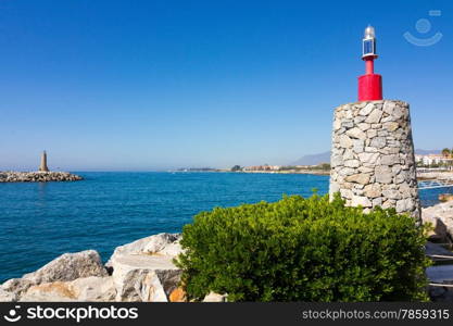 Lighthouse entrance to the pier of Puerto Banus, Malaga Spain