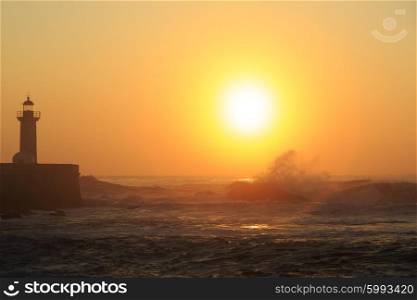 Lighthouse Felgueirasin Porto with wave splash at sunset, Porto, Portugal&#xA;
