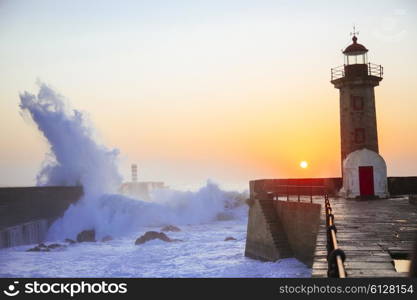 Lighthouse Felgueirasin Porto with wave splash at sunset, Porto, Portugal&#xA;