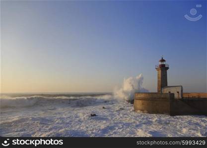 Lighthouse Felgueirasin Porto with waves and cityscape, sunny day&#xA;