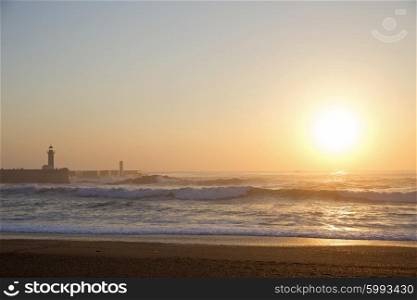 Lighthouse Felgueirasin Porto with waves and sun at sunset&#xA;