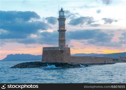 Lighthouse in Chania. Greece.. Old stone lighthouse in the Venetian harbor at dawn. Chania. Crete.