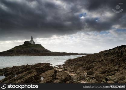Lighthouse landscape with stormy sky over sea