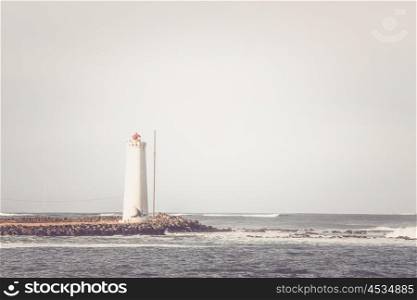 Lighthouse on a small island in the ocean