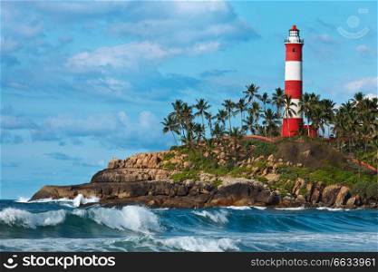 Lighthouse on rocky cliff and sea with waves. Lighthouse on cliff