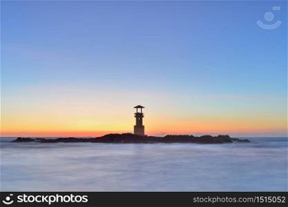 Lighthouse on sea in twilight