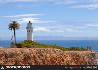 Lighthouse on the hill above ocean&#xA;