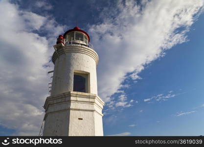 Lighthouse on the seashore in the solar morning