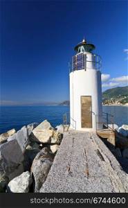 lighthouse over Mediterranean sea in Camogli, Italy
