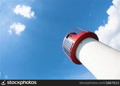 Lighthouse Photovoltaic Sky . Sea Mark at the harbor with blue sky with clouds in background