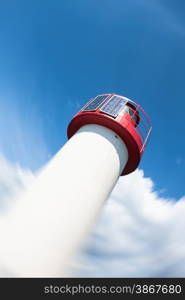 Lighthouse Photovoltaic Sky . Sea Mark at the harbor with blue sky with clouds in background