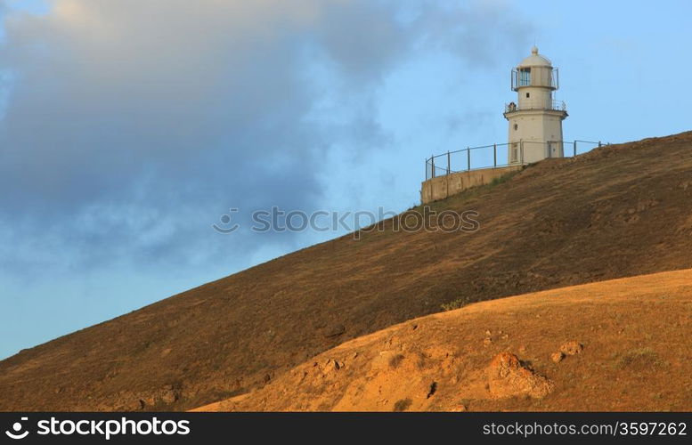 Lighthouse. The movement of clouds on the mountain Meganom, Crimea, Ukraine