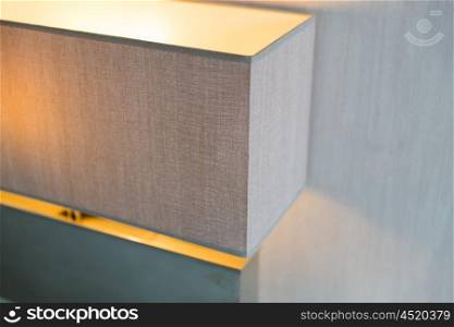 lighting, electricity and interior concept - close up of lamp at home