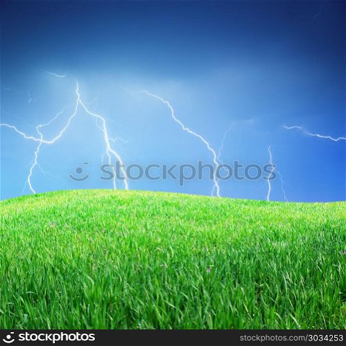 Lightning and green meadow. Nature composition.. Lightning and green meadow