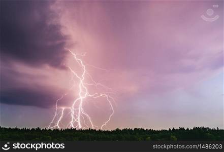 Lightning bolt at night over rural area. Agriculture fields.. Dramatic lightning bolt at night over rural area. Agriculture fields.