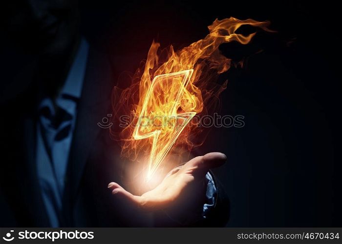 Lightning bright icon. Glowing power lightning icon in palm on dark background