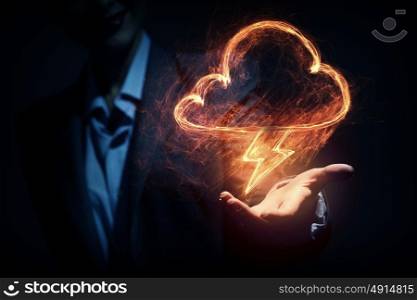 Lightning bright icon. Glowing power lightning icon in palm on dark background