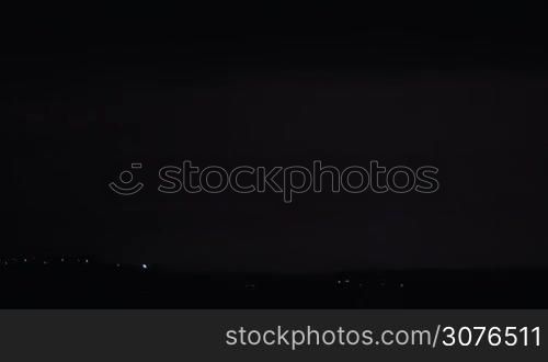 Lightning discharge in the dark sky during night thunderstorm