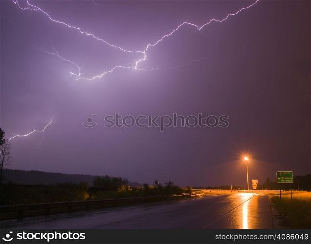 Lightning erupts over a lonley highway onramp in Nisquallly Valley
