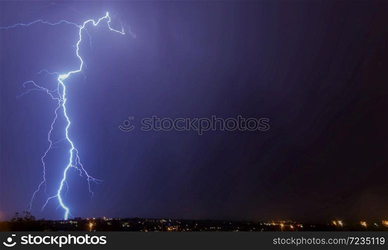 Lightning strikes to ground on purple sky