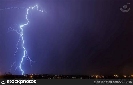 Lightning strikes to ground on purple sky