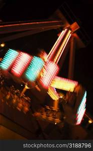 Lights glowing on a carnival ride at night, California, USA