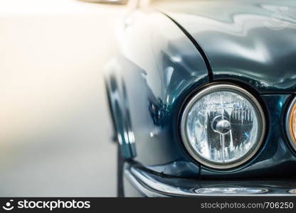 Lights of a reflecting green vintage car