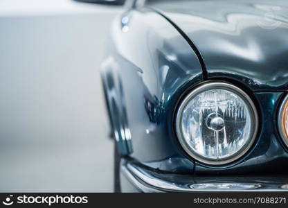 Lights of a reflecting green vintage car