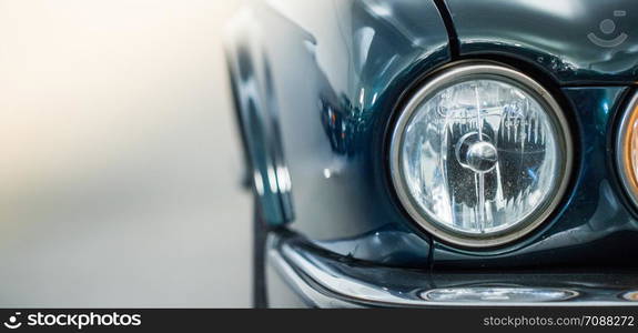 Lights of a reflecting green vintage car