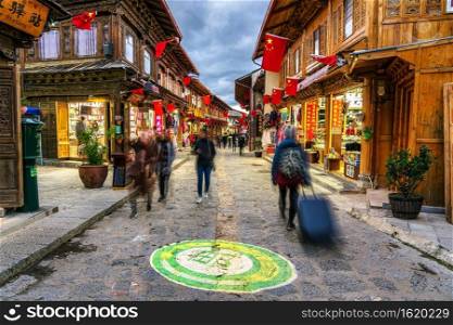 LIJIANG, CHINA - OCTOBER 2019   Scenic view of the Dukezong ancient Old Town with tourist at evening time on October 22, 2019. is the historical center of Lijiang City, in Yunnan, China. 