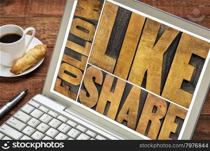 like, share, follow word abstract - networking and social media concept - text in letterpress wood type on a laptop screen with a cup of coffee