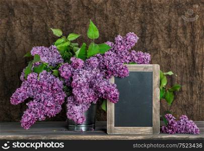 Lilac flowers bouquet and vintage chalkboard for Your text