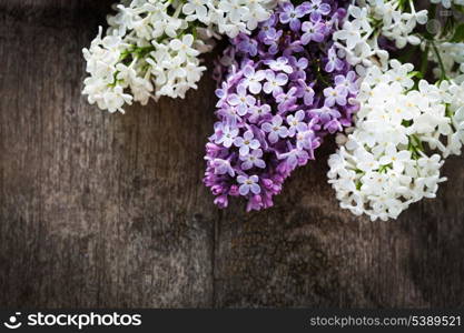 Lilac flowers closeup, on the wooden table for design