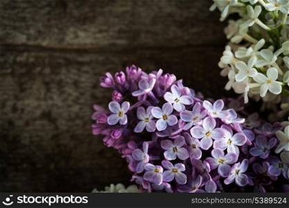 Lilac flowers closeup, on the wooden table for design