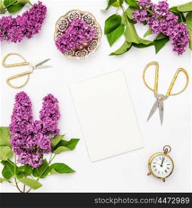 Lilac flowers, notebook, golden accessories. Flat lay sketchbook, top view