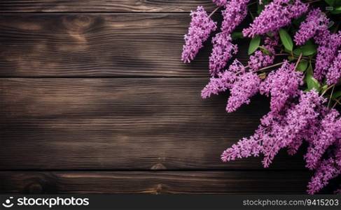 Lilac flowers on wooden background. Top view with copy space